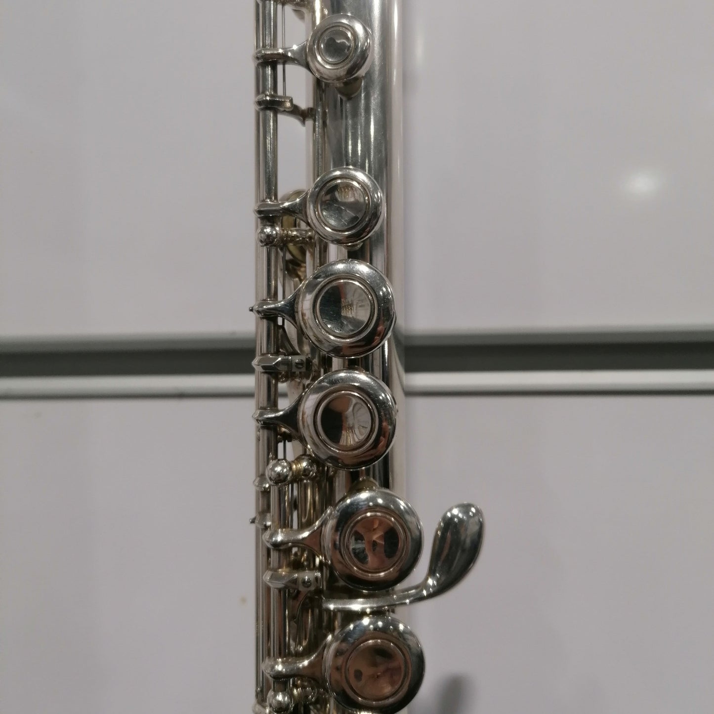 Close-up of a silver flute on a white background