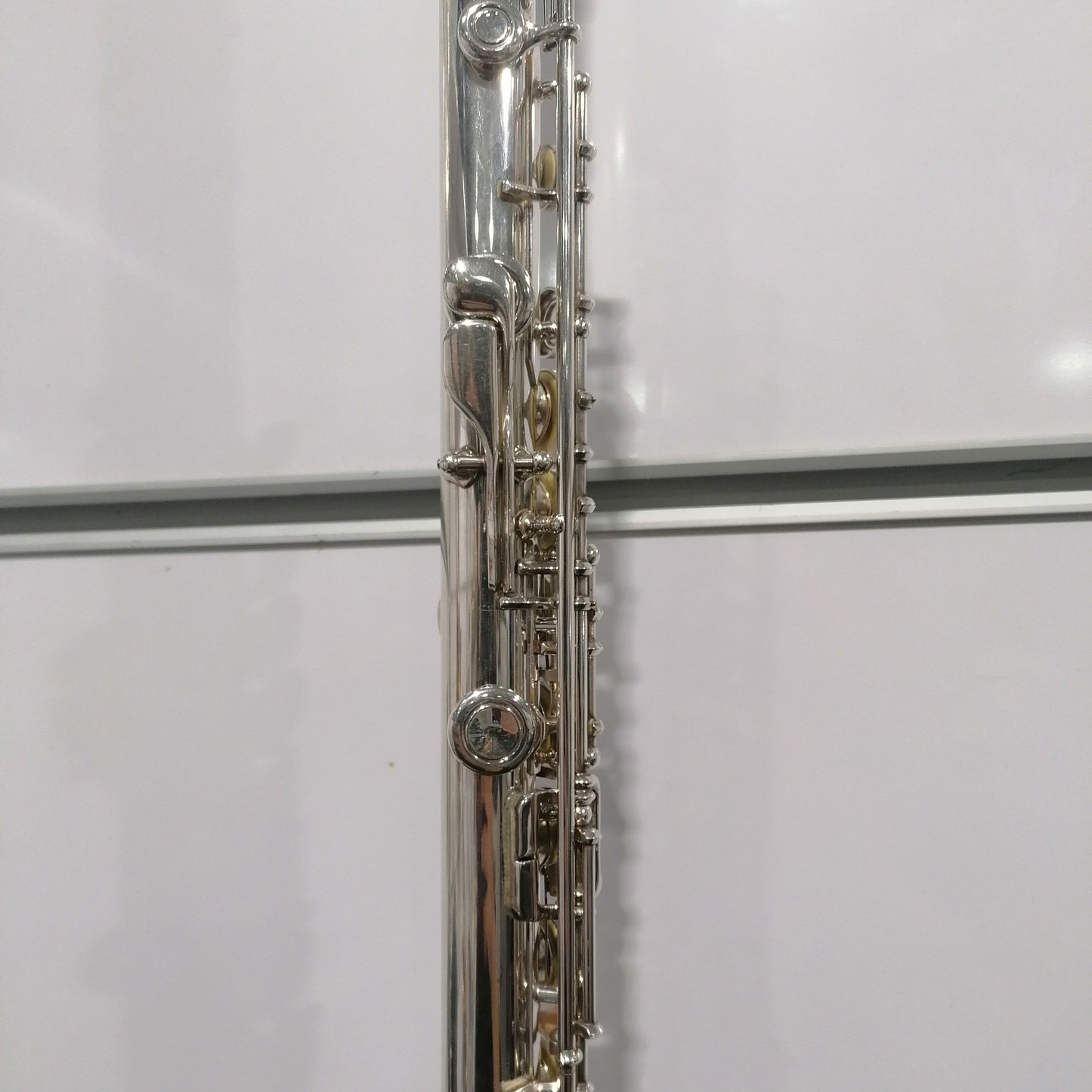 Close-up of a silver flute on a white background