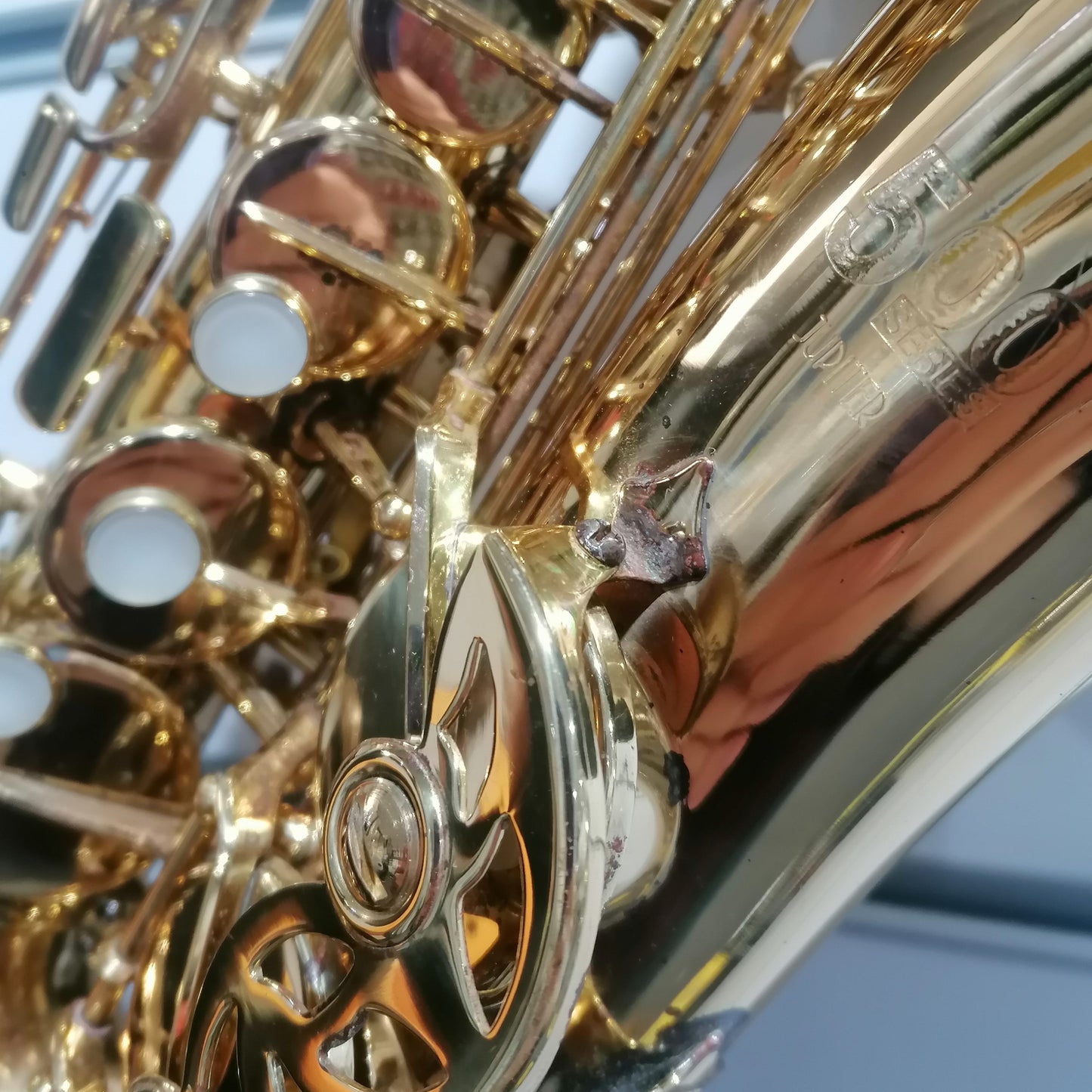 Close-up of a gold saxophone with a blurred background