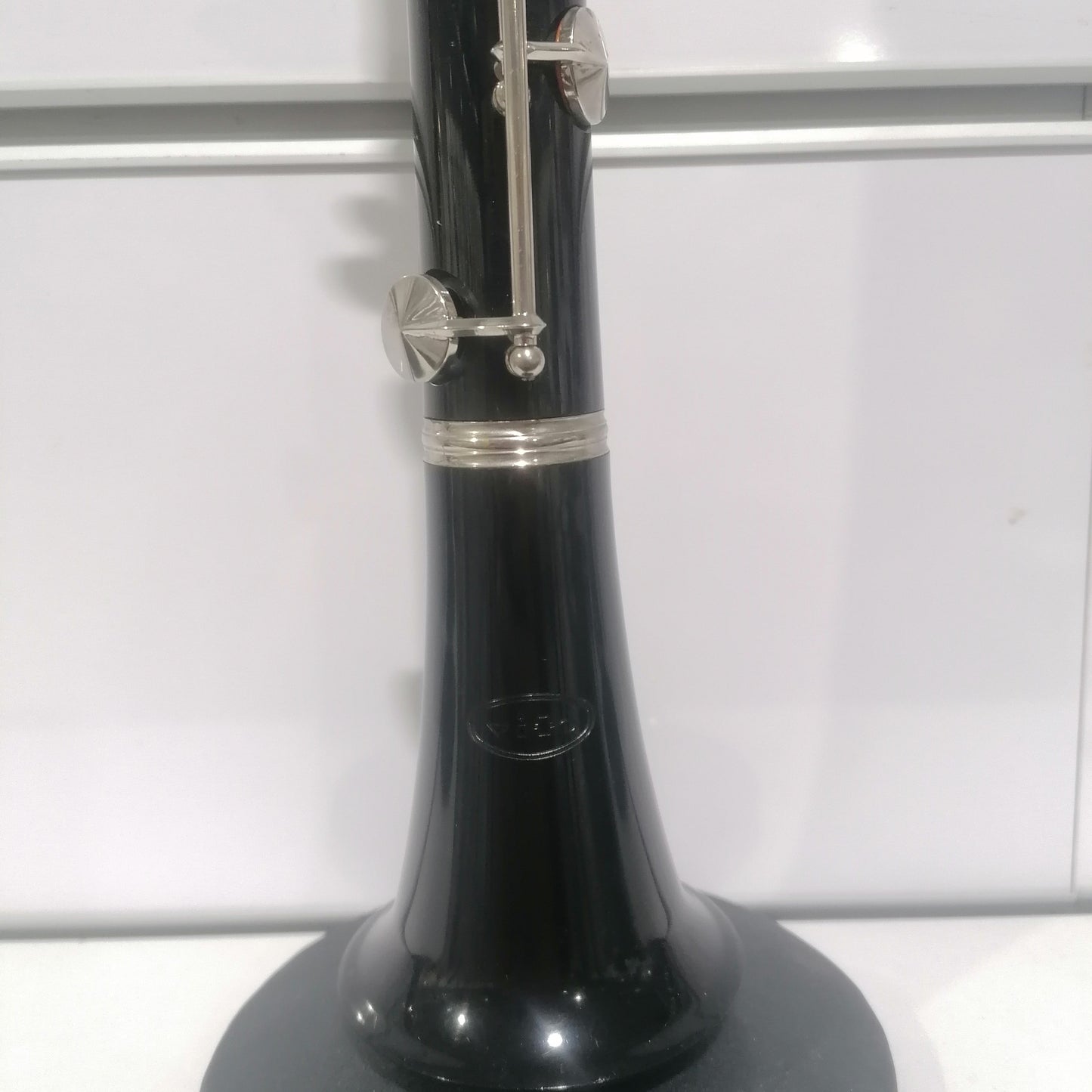 Black clarinet with silver keys on a white background