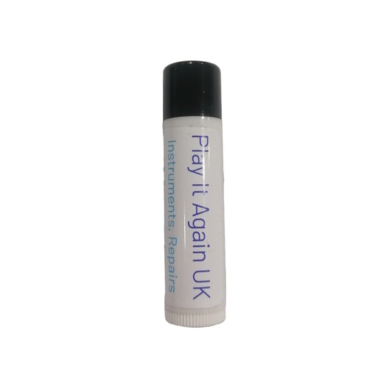 White tube with black cap labeled 'Play it Again UK' on a light gray background