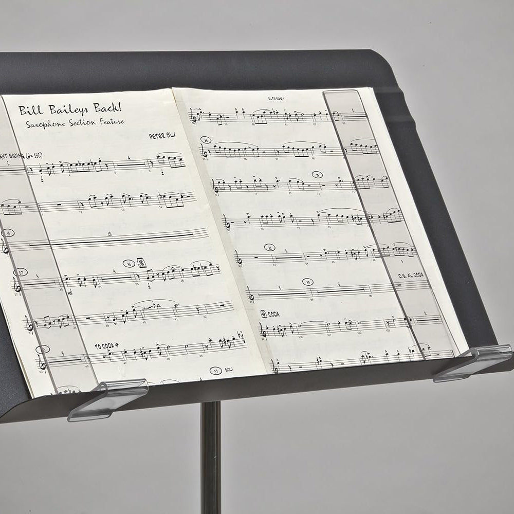 Music stand with sheet music on a gray background