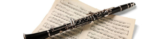 Clarinet lying over sheet music