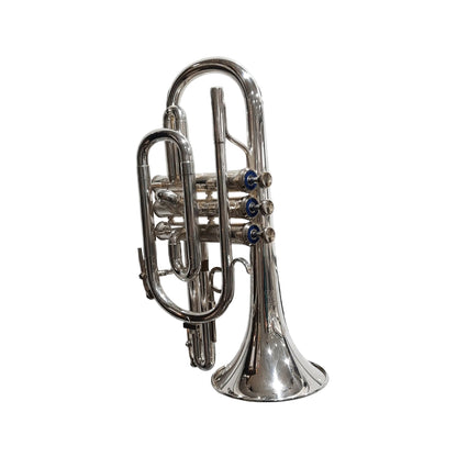Silver trumpet on a white tiled wall