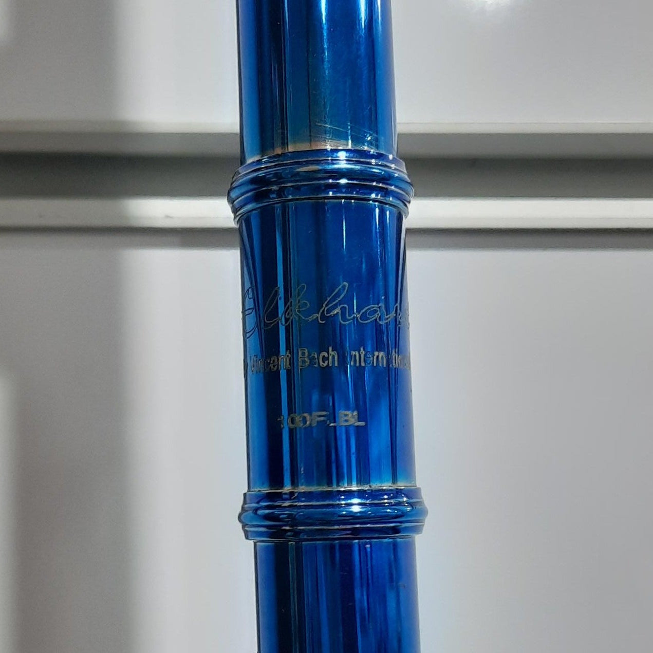 Blue flute with gold accents on a white background