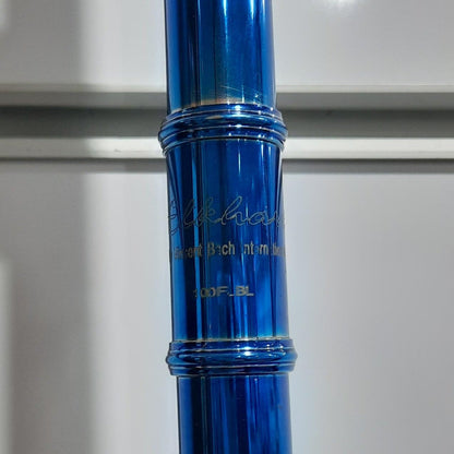 Blue flute with gold accents on a white background