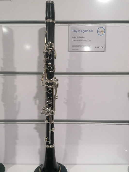 Clarinet on display with a 'Play It Again UK' sign in the background