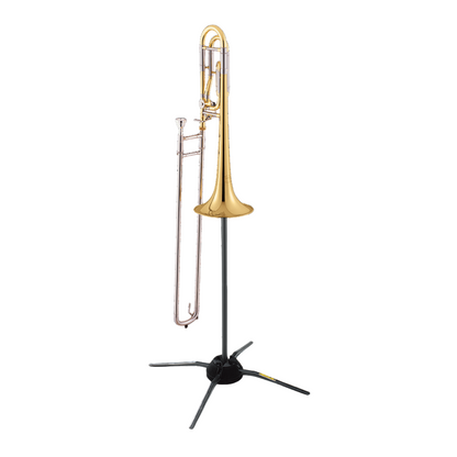 Gold trombone on a black stand against a white background