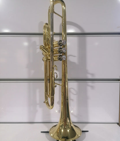 Gold trumpet on a stand against a white background