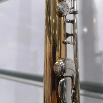 Close-up of a gold and silver musical instrument on a white background
