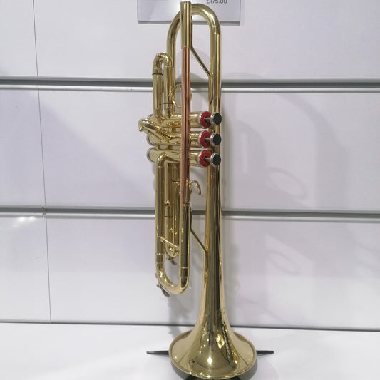 Gold trumpet on a stand with a white background