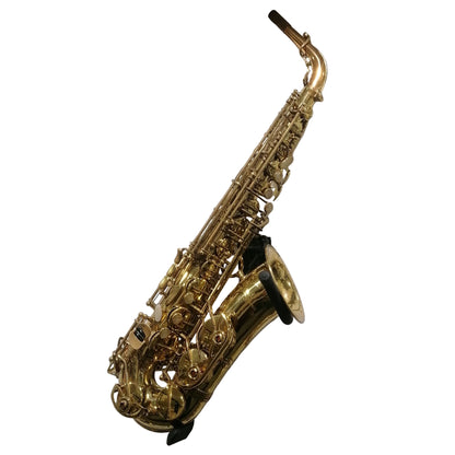 Gold saxophone on a white wall with a label below