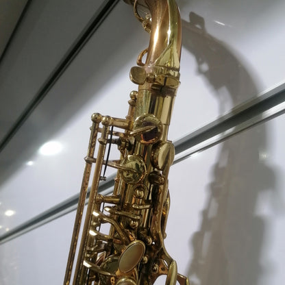 Gold saxophone on a white background