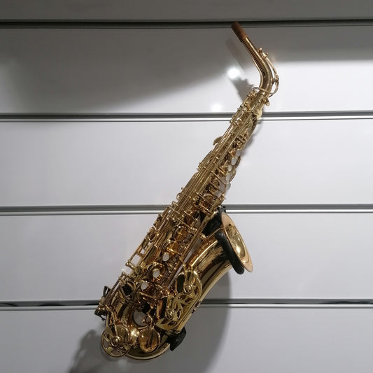 Gold saxophone on a gray slatted background