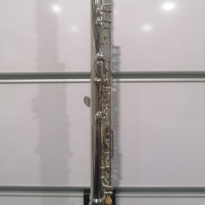 Silver flute against a white background