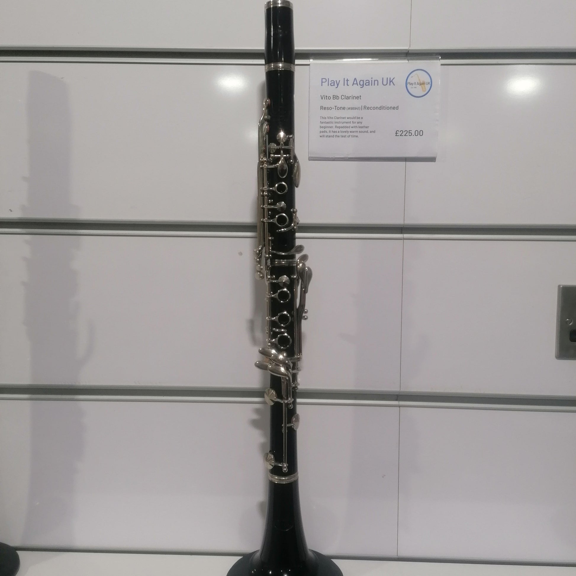 Clarinet on a stand with a white background
