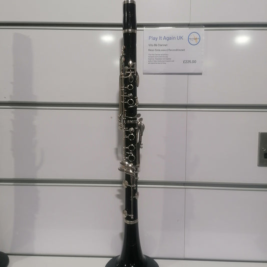Clarinet on a stand with a white background