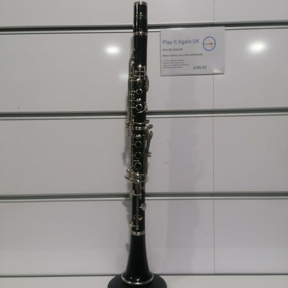 Clarinet on a white surface with a white wall background