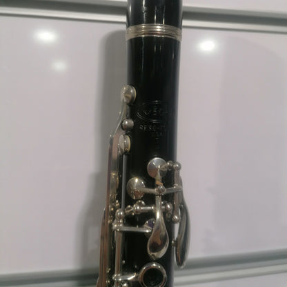 Black clarinet with silver keys on a white background