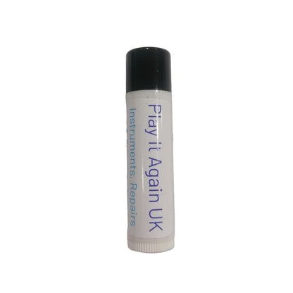 White tube with black cap labeled 'Play it Again UK' on a light gray background