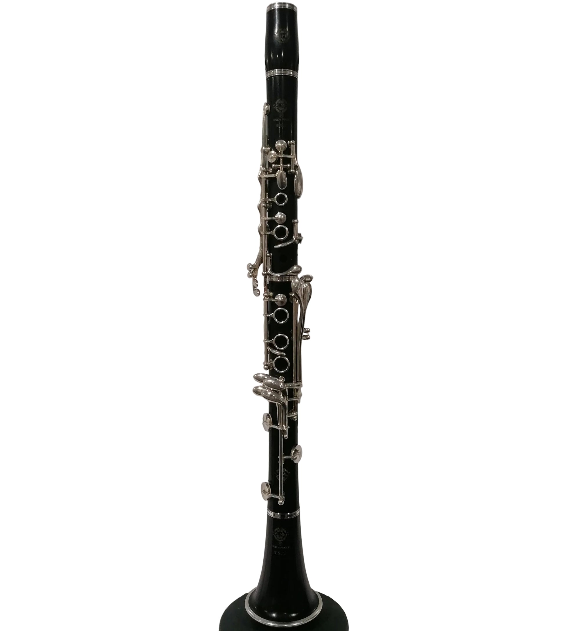 Black clarinet on a stand against a white background