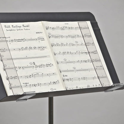 Music stand with sheet music on a gray background